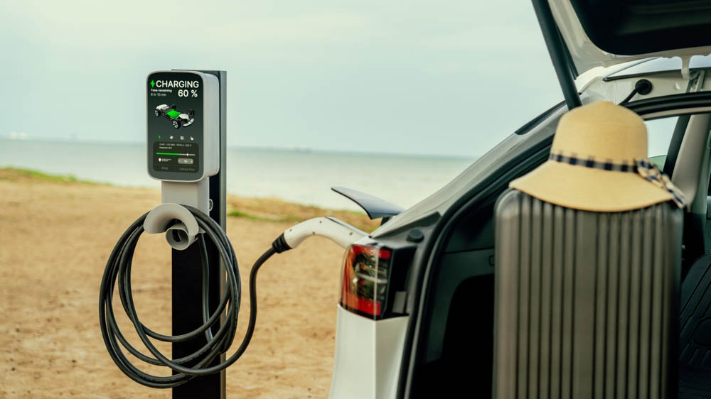 electric car recharging battery on the beach